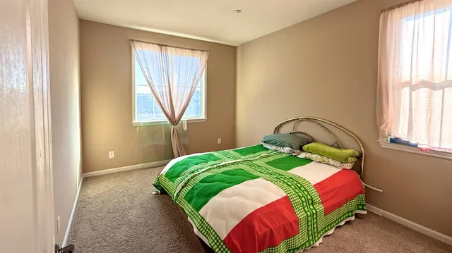 a bedroom with a bed and window