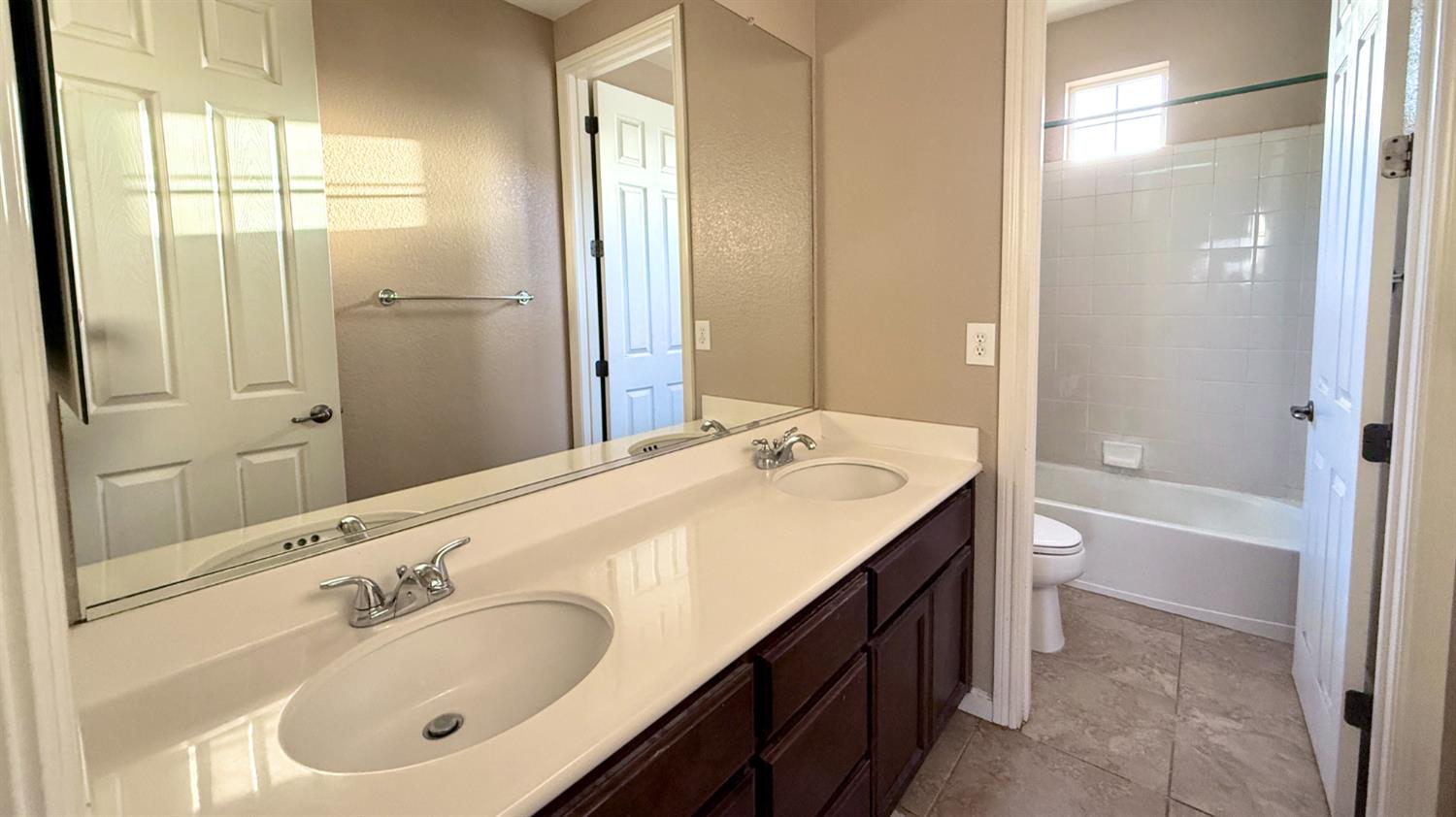 16206 Sand Bar Way Lathrop, CA 95330 - Photo 27 of 32 a bathroom with a tub sink and mirror