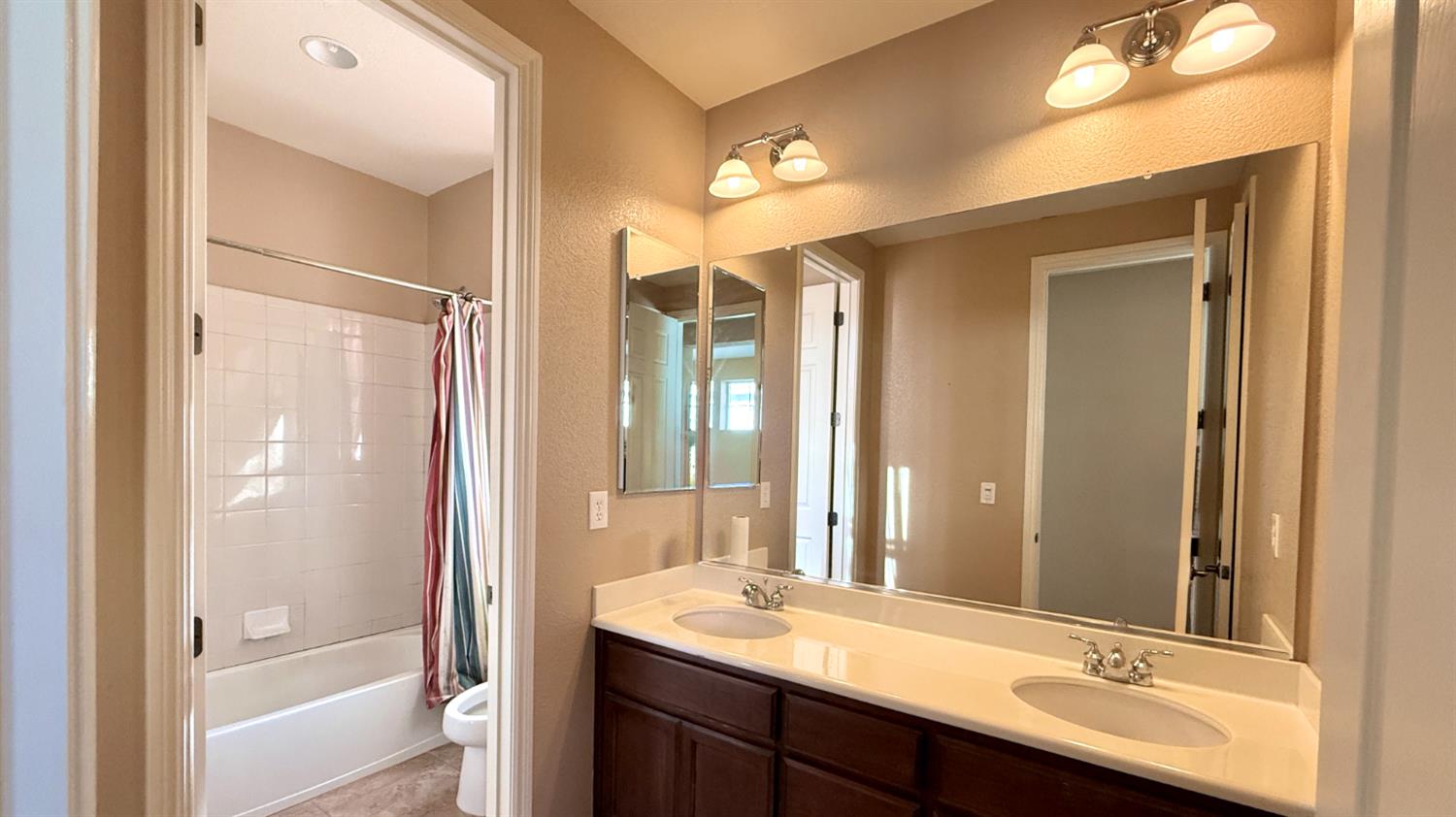 16206 Sand Bar Way Lathrop, CA 95330 - Photo 28 of 32 a bathroom with a sink and a mirror