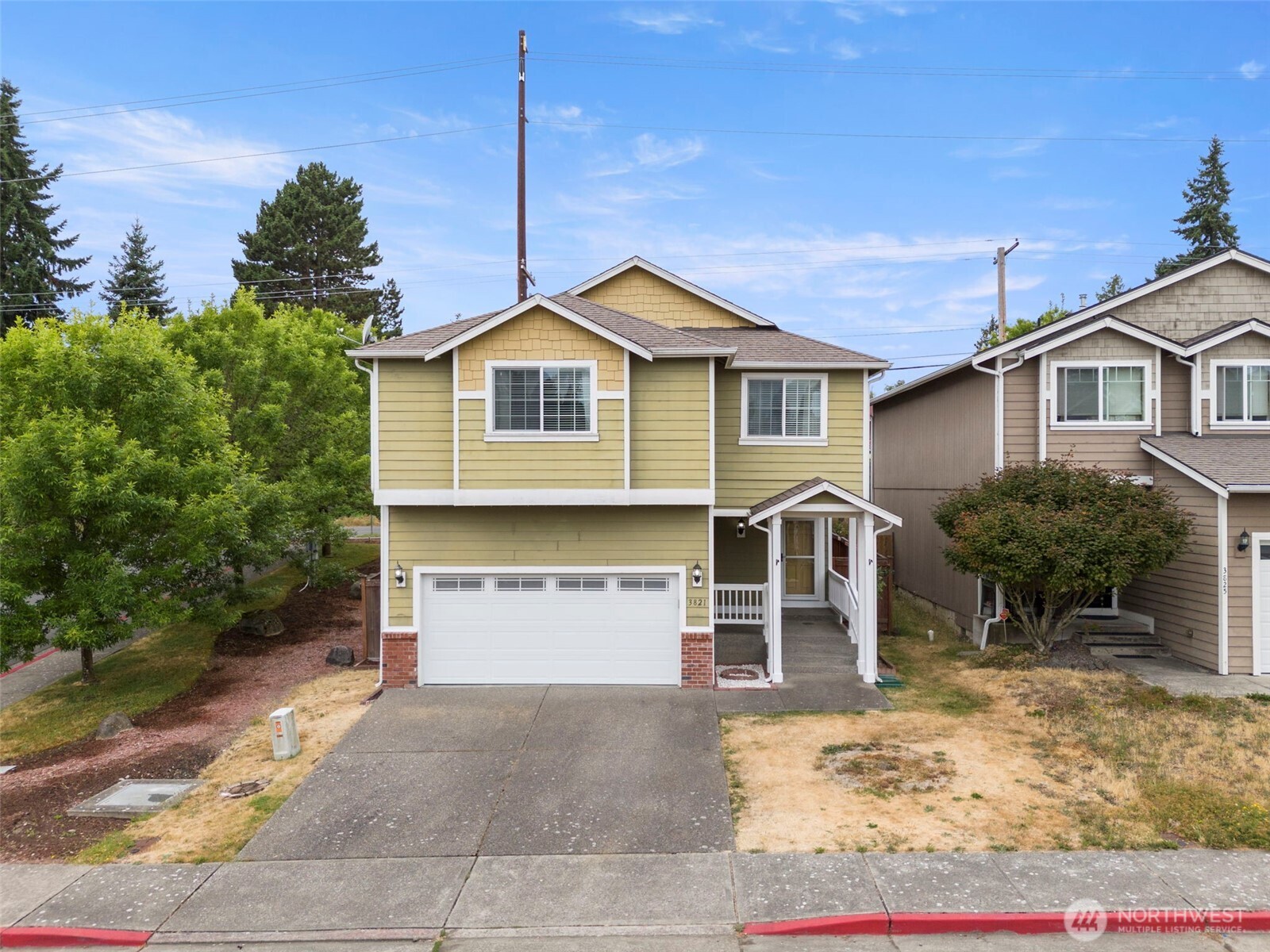 a front view of a house with a yard and garage