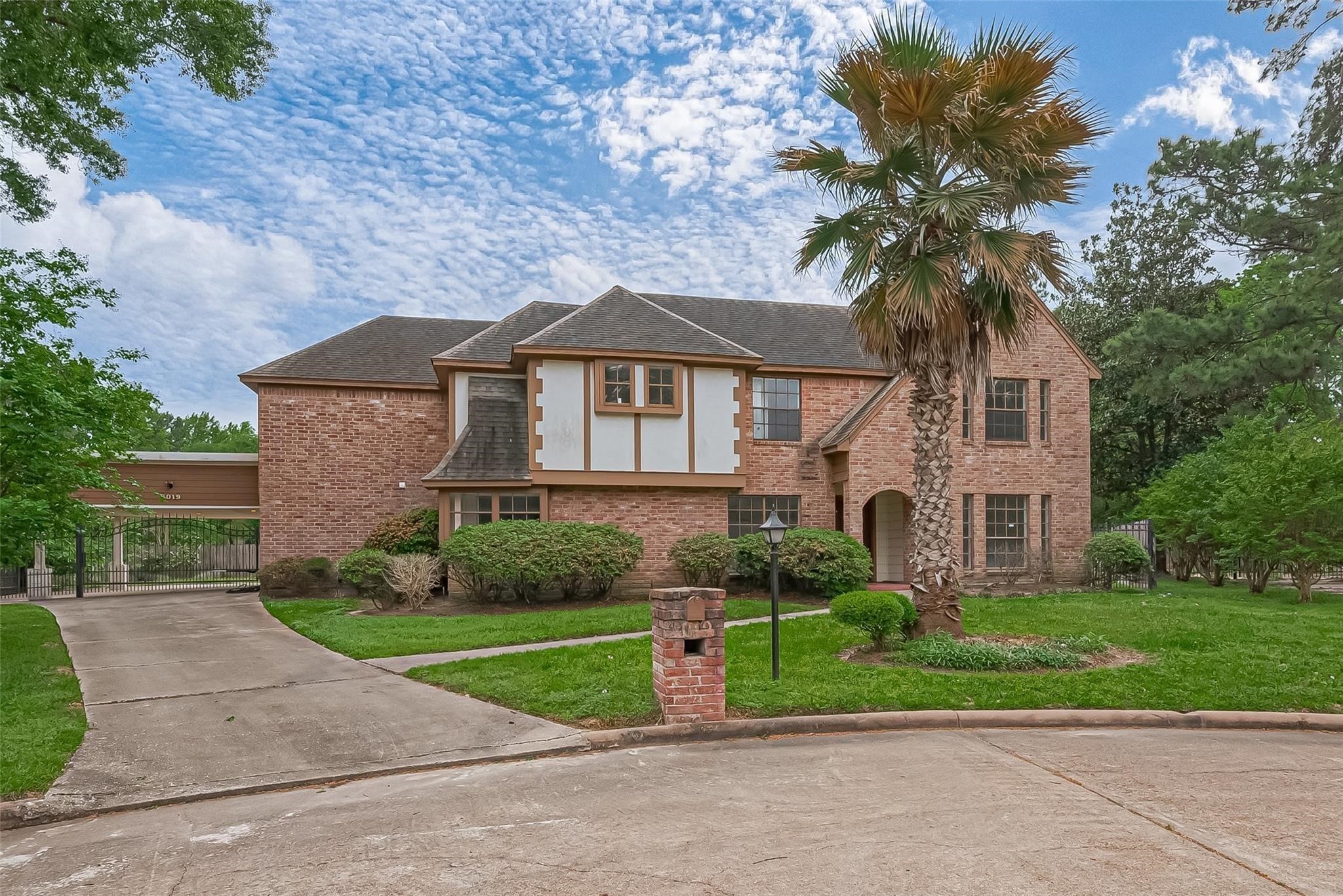 8019 Beaufort Drive Spring, TX 77379 - Photo 8 of 47 a front view of a house with a yard and potted plants