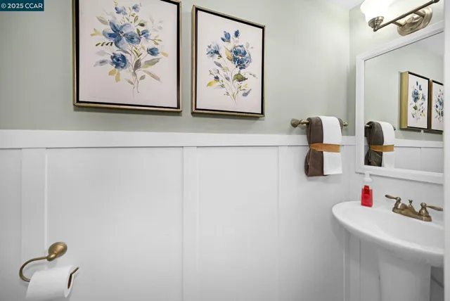 a white bath tub sitting next to a white wall