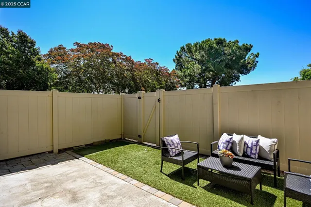 a backyard of a house with table and chairs