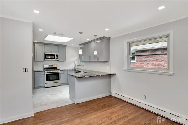 a kitchen with stainless steel appliances granite countertop a stove and a sink