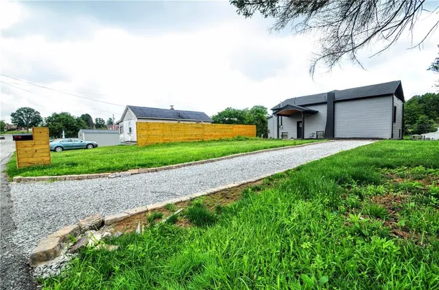 a view of a backyard with large trees