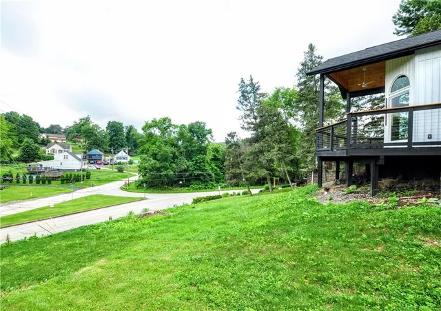 a view of a house with a backyard