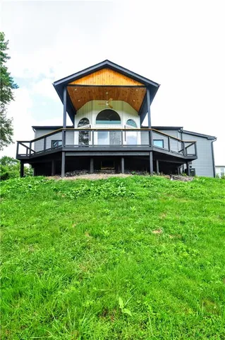 a view of a house with a yard and sitting area