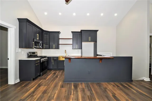 a kitchen with stainless steel appliances a refrigerator and a stove top oven