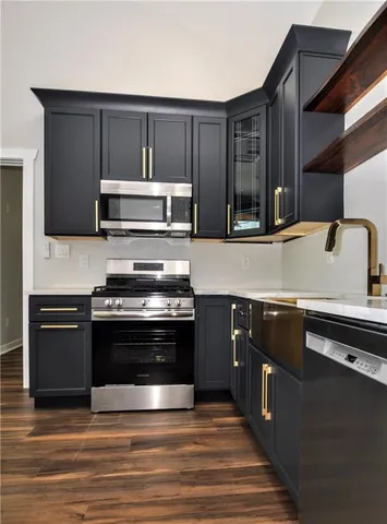 a kitchen with granite countertop stainless steel appliances and wooden cabinets