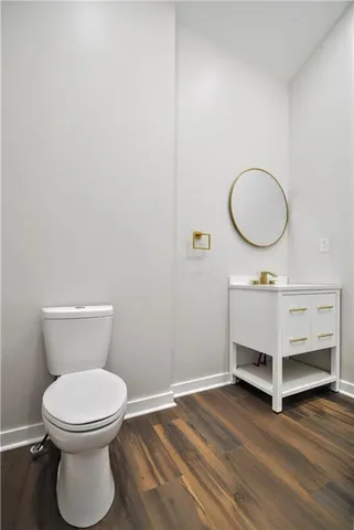 a view of a hallway with wooden floor and entryway