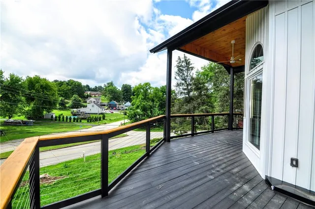 a view of balcony with wooden floor and fence