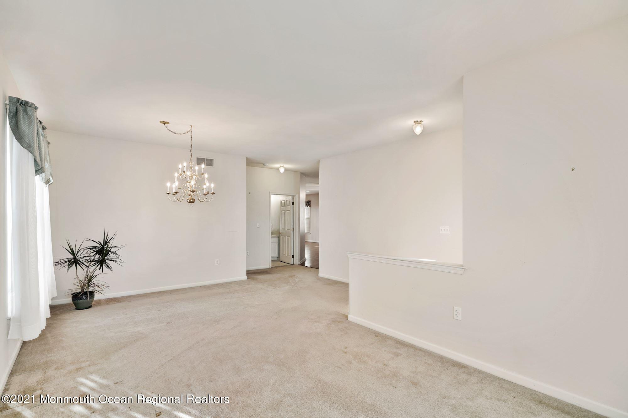 81 Byron Road Brick, NJ 08724 - Photo 14 of 51 an empty room with chandelier fan and windows