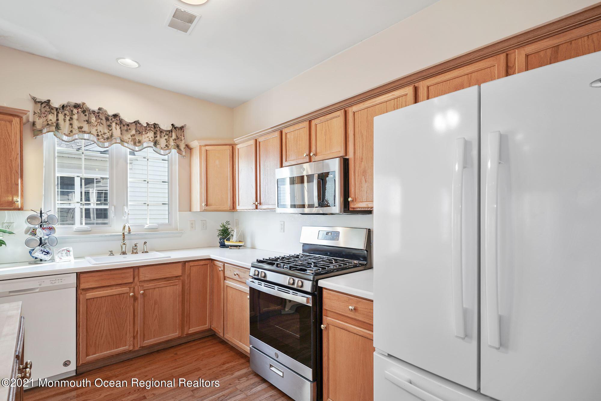 81 Byron Road Brick, NJ 08724 - Photo 19 of 51 a kitchen with stainless steel appliances a sink stove and cabinets