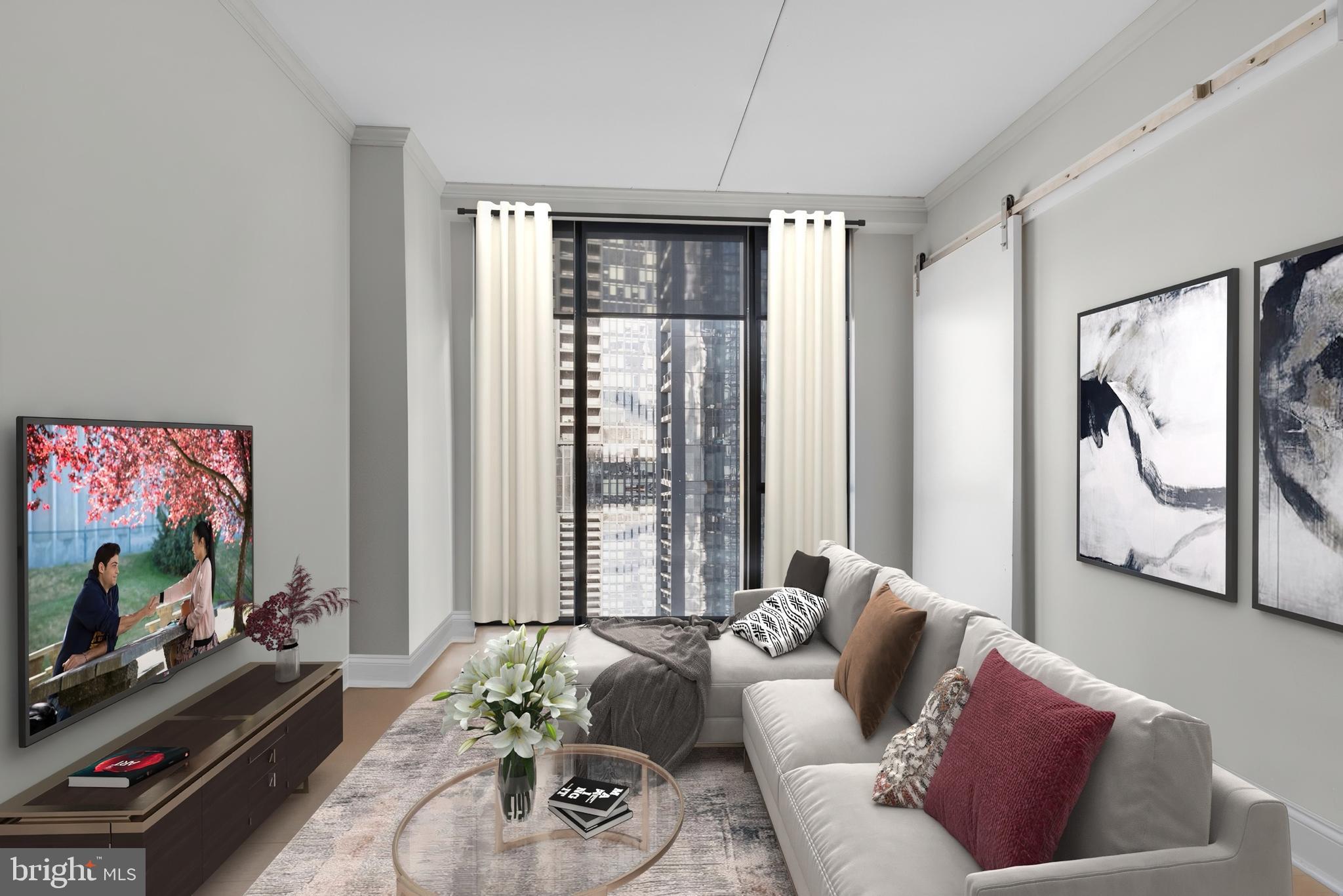 2301-61 John F Kennedy Boulevard, Unit 1001 Philadelphia, PA 19103 - Photo 25 of 39 a living room with furniture and a flat screen tv