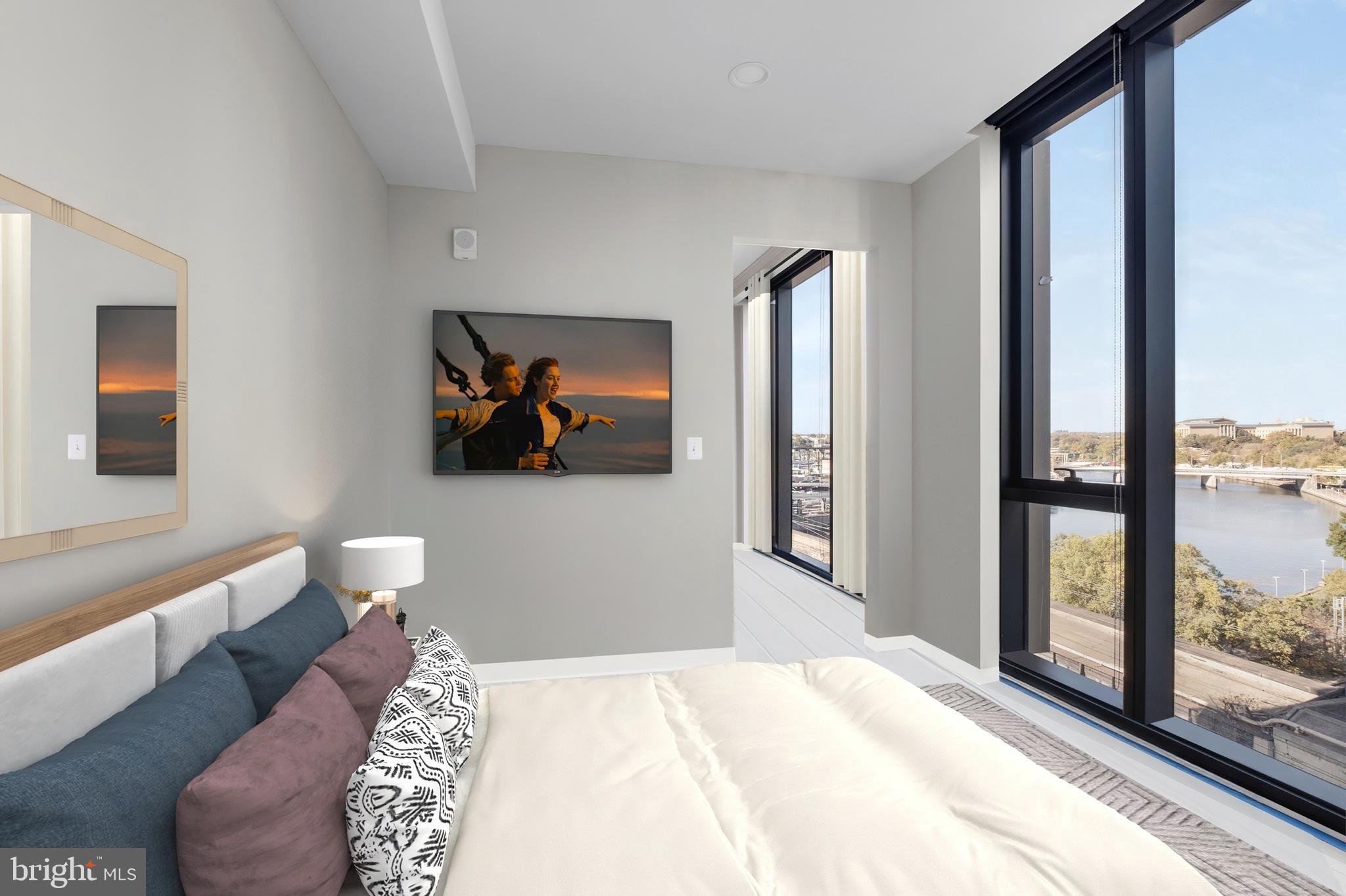 2301-61 John F Kennedy Boulevard, Unit 1001 Philadelphia, PA 19103 - Photo 26 of 39 a bedroom with a bed and glass windows