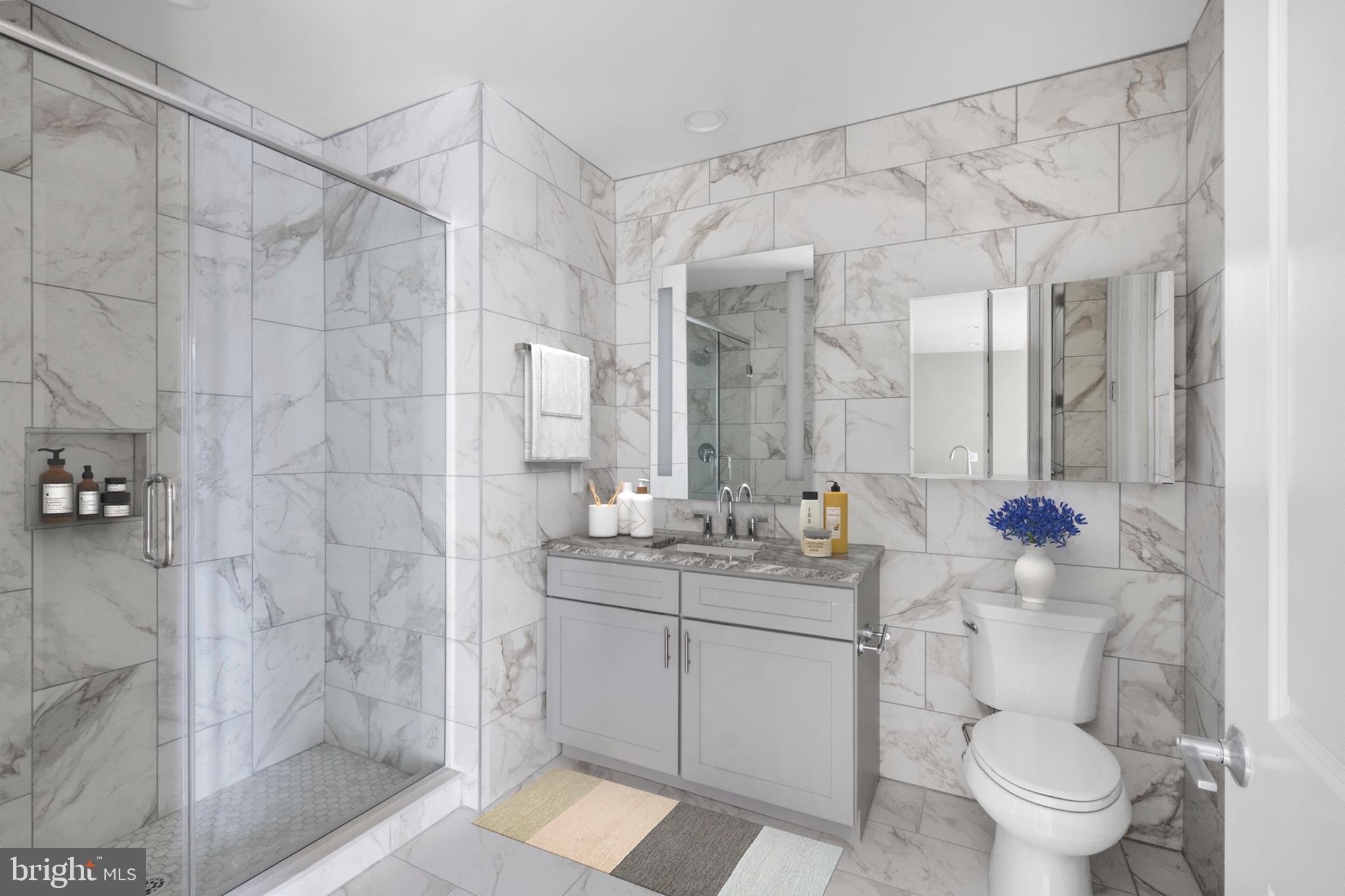 2301-61 John F Kennedy Boulevard, Unit 1001 Philadelphia, PA 19103 - Photo 30 of 39 a bathroom with a sink a toilet and shower