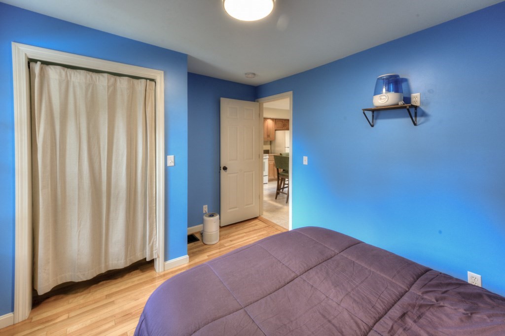 20 Alpine Trail Auburn, MA 01501 - Photo 12 of 40 a bedroom with a bed and a chandelier