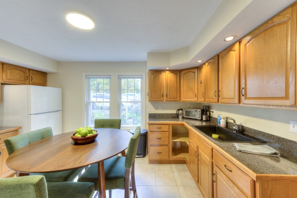 20 Alpine Trail Auburn, MA 01501 - Photo 18 of 40 a kitchen with a dining table chairs and sink