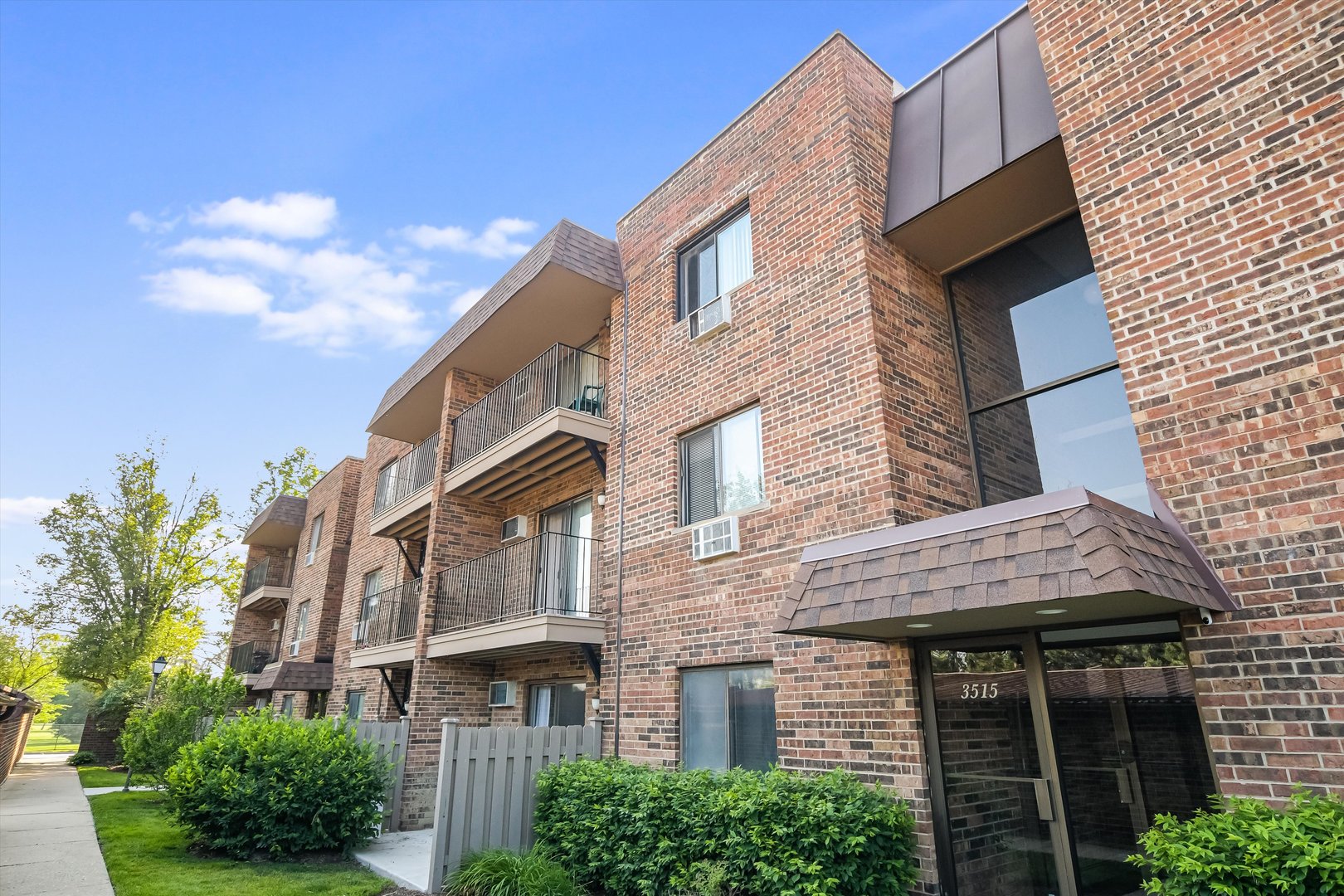 a view of a brick building with many windows