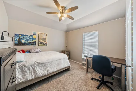 a bedroom with a bed chair and a window