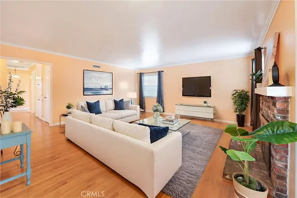 a living room with furniture flat screen tv and a fireplace