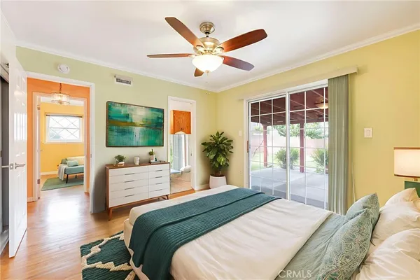 a bedroom with a large bed and a flat screen tv