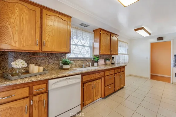 a kitchen with stainless steel appliances granite countertop a sink and cabinets