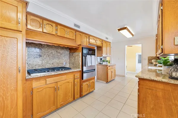 a kitchen with stainless steel appliances granite countertop a sink and cabinets