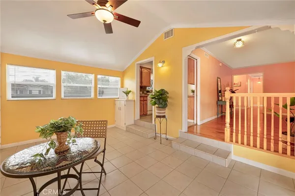 a view of a livingroom with furniture wooden floor and a ceiling fan