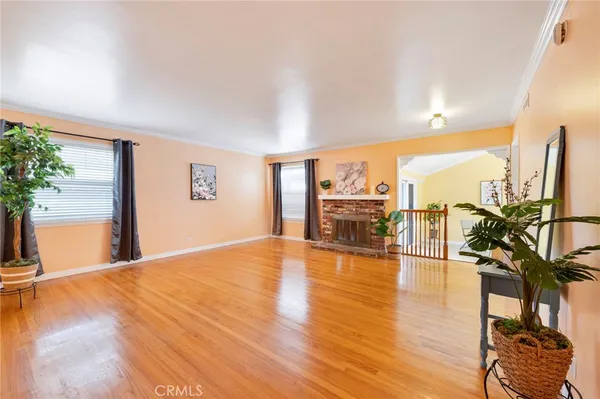a view of a living room and floor to ceiling window and wooden floor