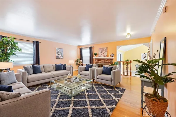 a living room with furniture a rug and a floor to ceiling window