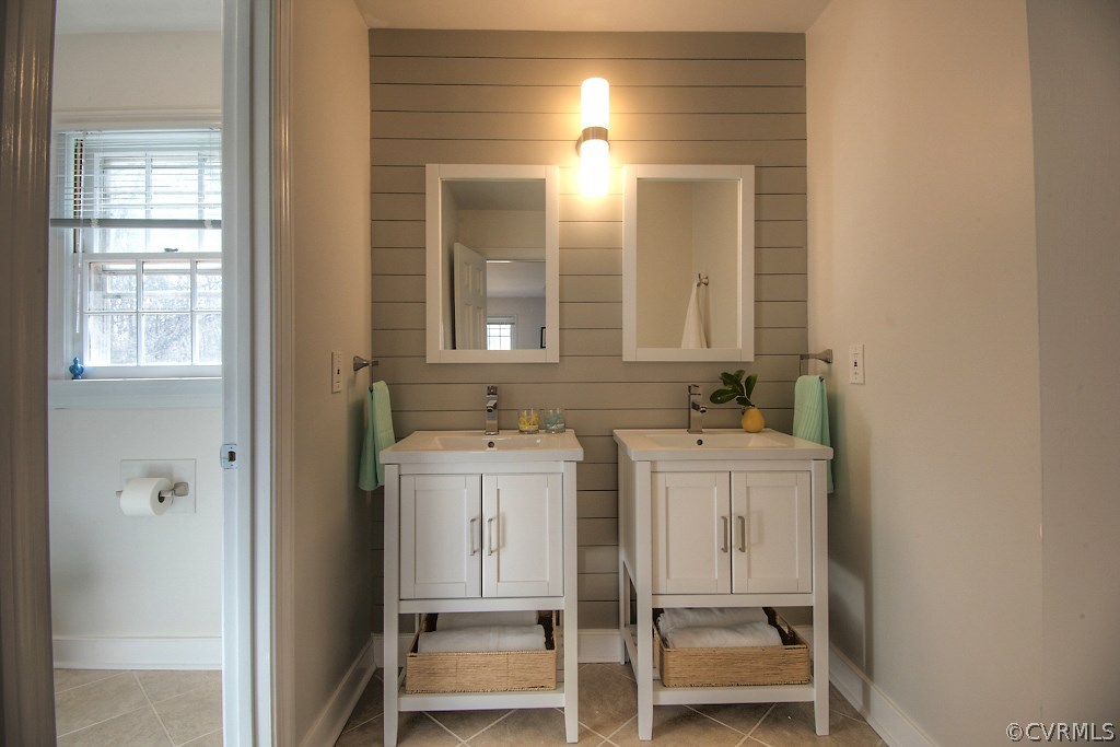 3121 East Brigstock Road Midlothian, VA 23113 - Photo 23 of 39 a bathroom with a double vanity sink and a mirror