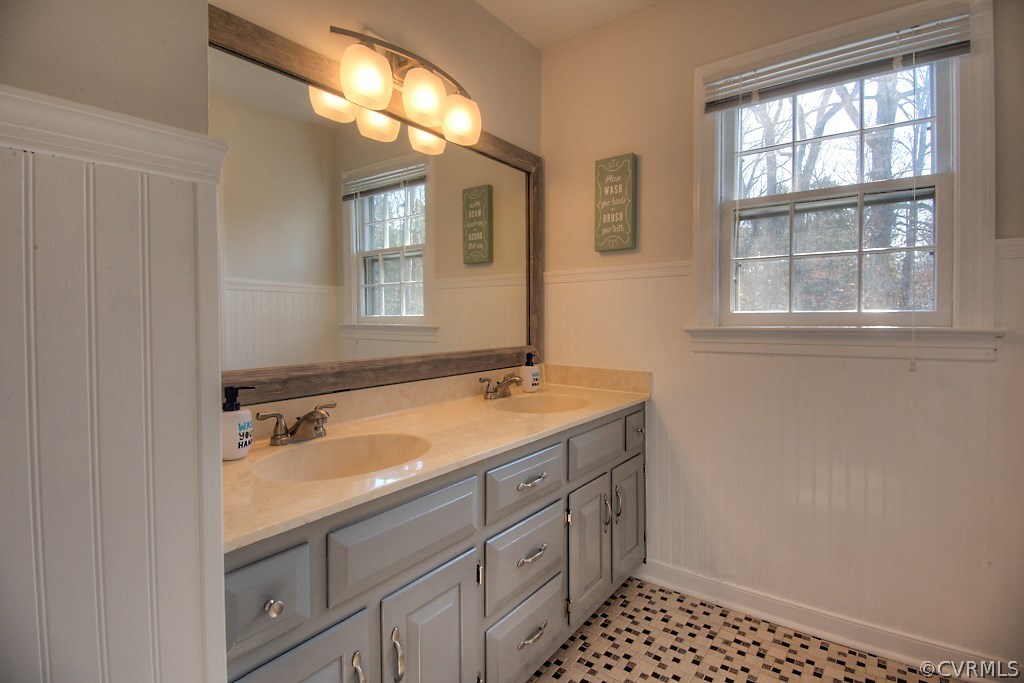 3121 East Brigstock Road Midlothian, VA 23113 - Photo 29 of 39 a bathroom with a sink a vanity and a mirror