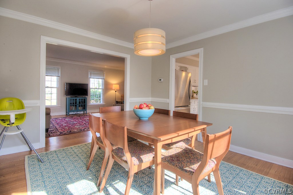 3121 East Brigstock Road Midlothian, VA 23113 - Photo 7 of 39 a view of a dining room with furniture and chandelier