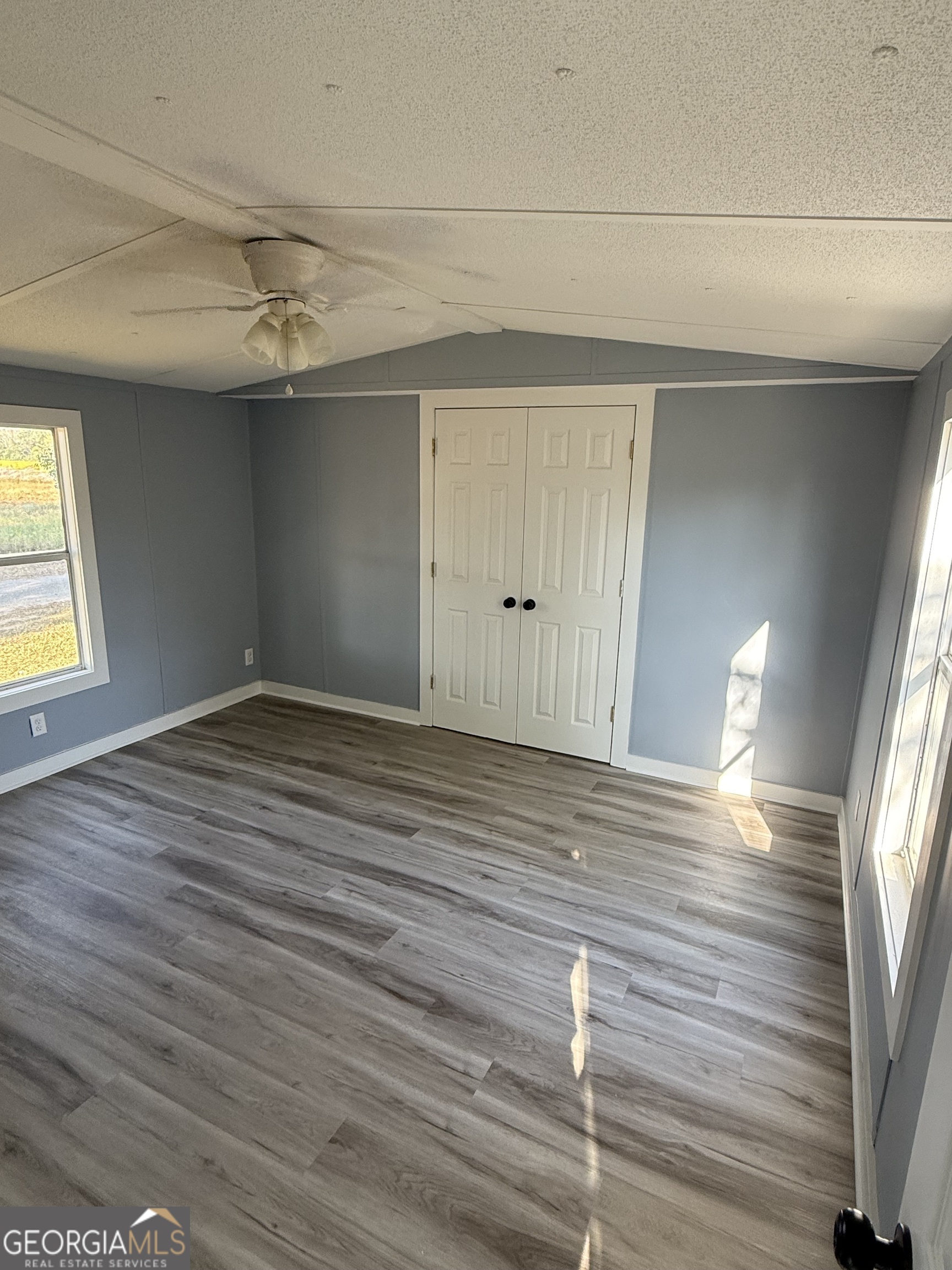 8410 Hawkinsville Road Macon, GA 31216 - Photo 18 of 22 a view of empty room with wooden floor and fan