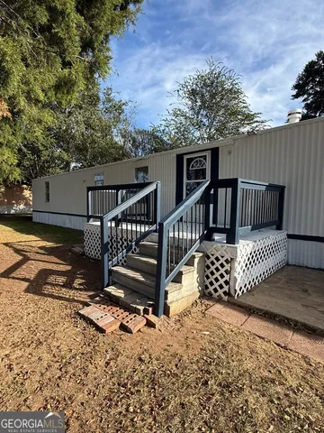 a view of a wooden deck with a yard