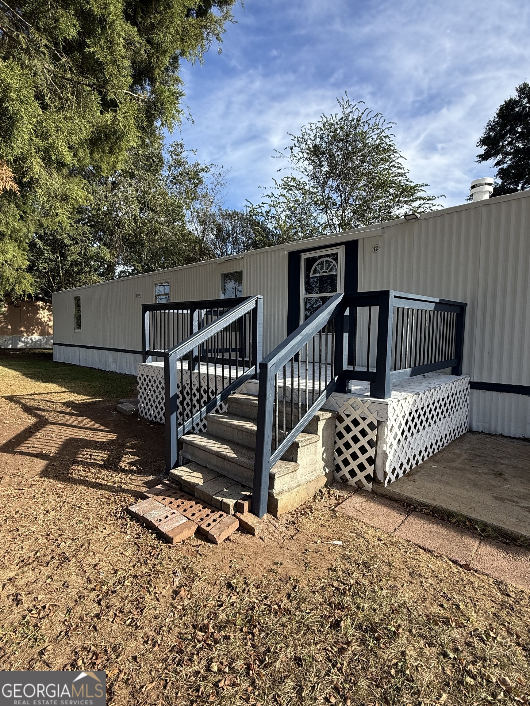 8410 Hawkinsville Road Macon, GA 31216 - Photo 2 of 22 a view of a wooden deck with a yard