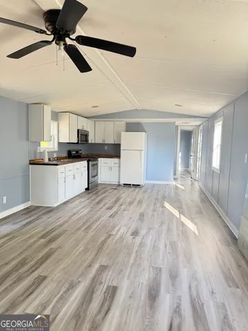 a view of a kitchen with a sink and cabinets