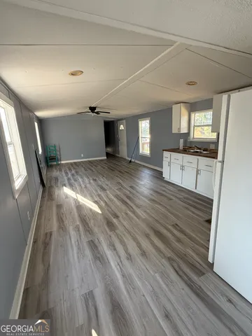 a view of a room with wooden floor and staircase