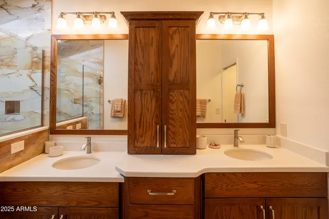 a bathroom with a sink vanity and a mirror