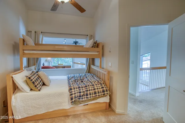 a living room with furniture a ceiling fan and a window