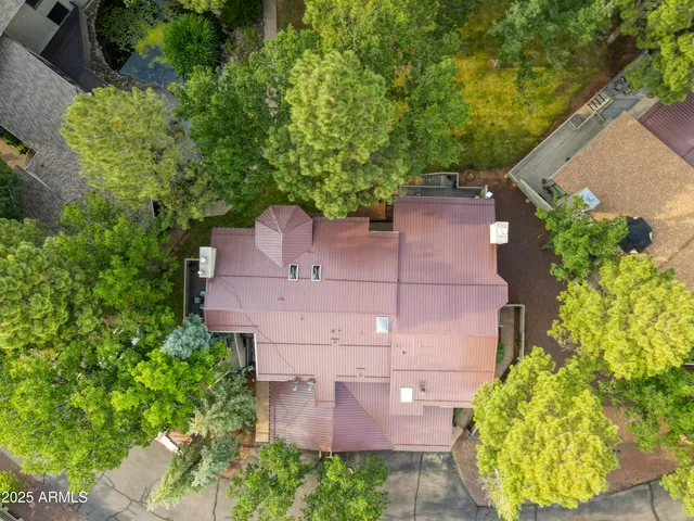 an aerial view of a house with a yard and garden