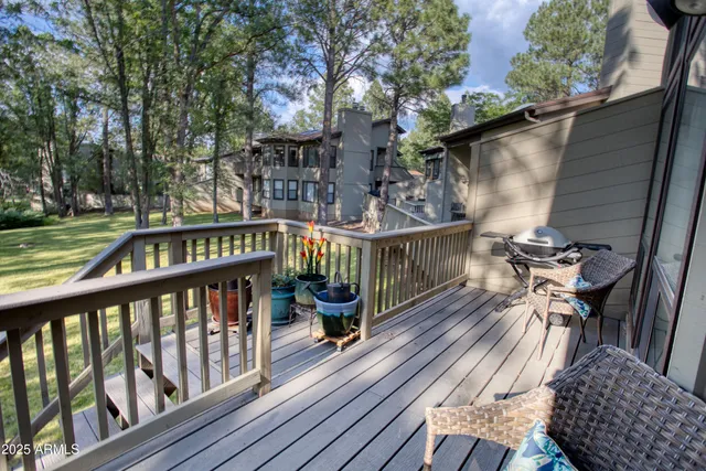 a view of balcony with wooden floor outdoor seating and yard in back