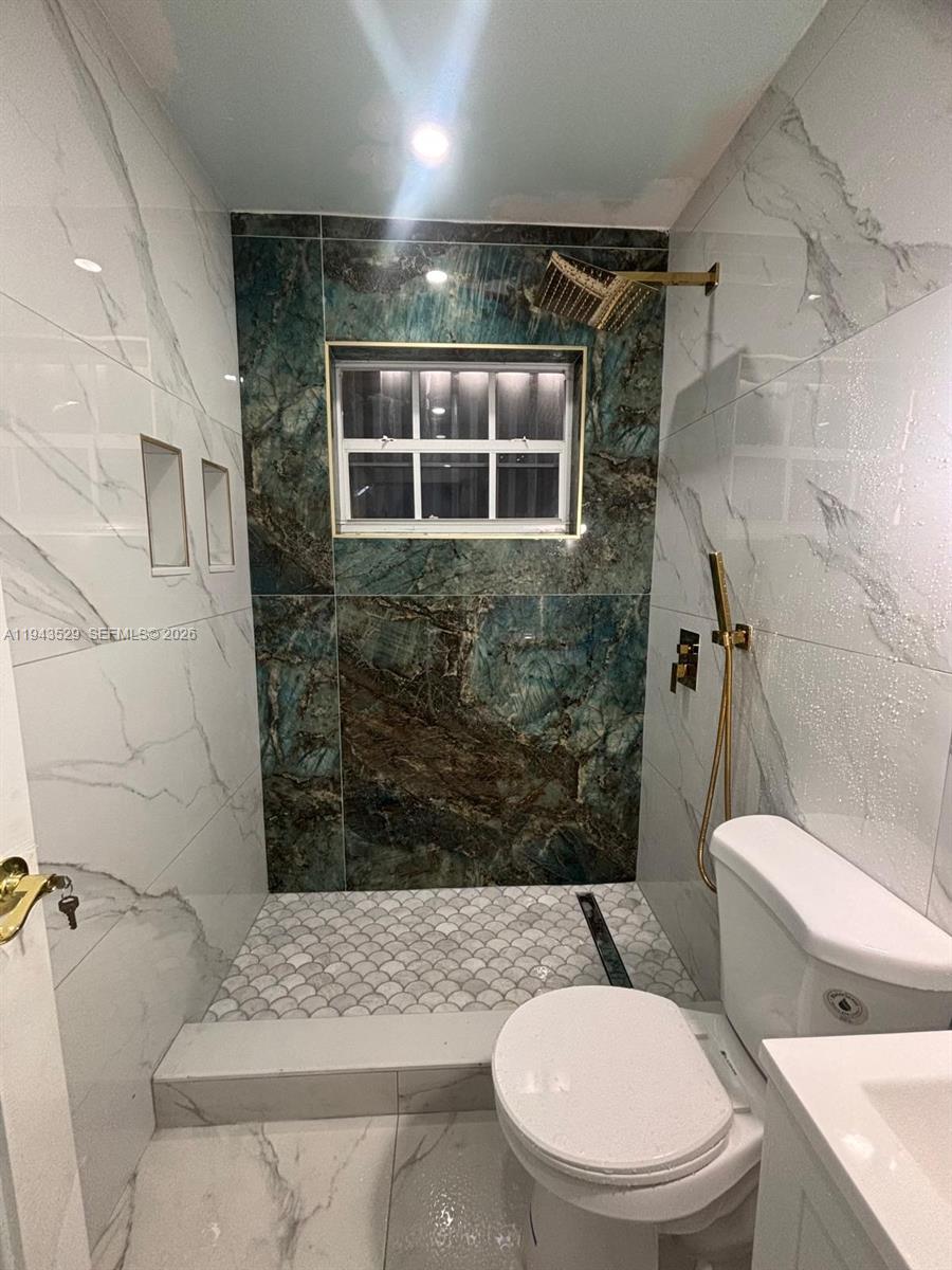 4380 Southwest 1st Street, Unit 1 Miami, FL 33134 - Photo 3 of 10 a bathroom with a toilet and a shower