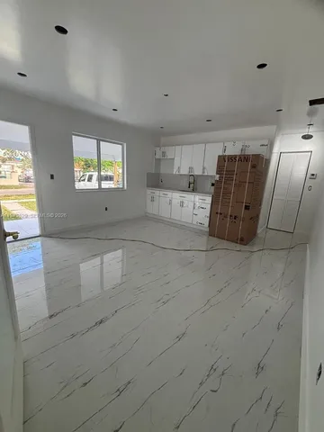 a view of a refrigerator in kitchen and utility room