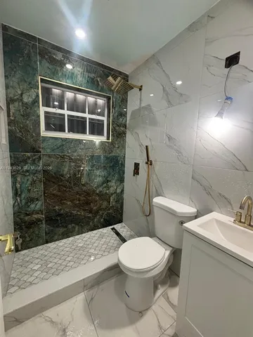 a bathroom with a toilet and a shower