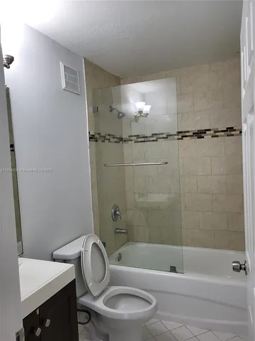 a bathroom with a toilet and a bathtub