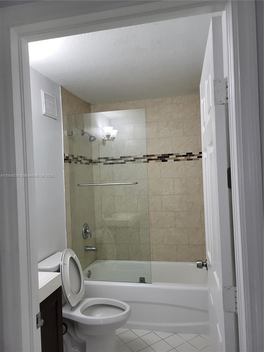 1240 Southeast 28th Court, Unit 201 Homestead, FL 33035 - Photo 10 of 10 a bathroom with a shower and a toilet