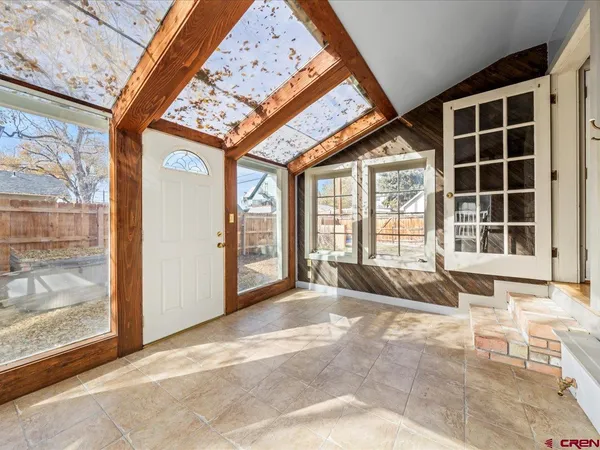 a living room with a large bed and a large window