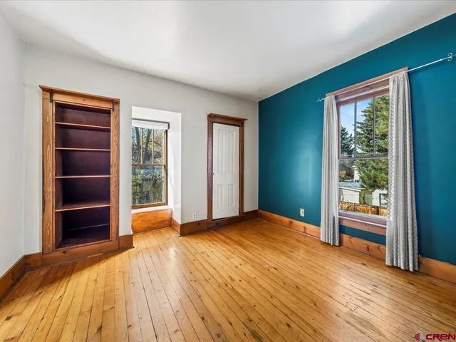 a view of a room with wooden floor
